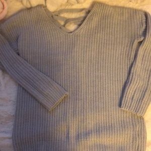 Light gray sweater with cross opening in the back